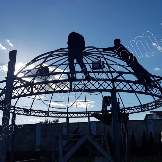 Installing the roof of a wrought-iron gazebo