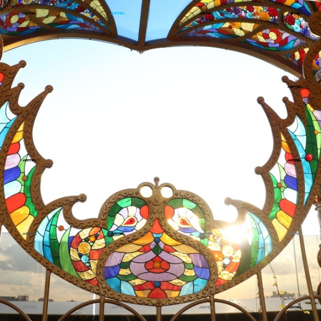 Wrought iron swing with stained glass